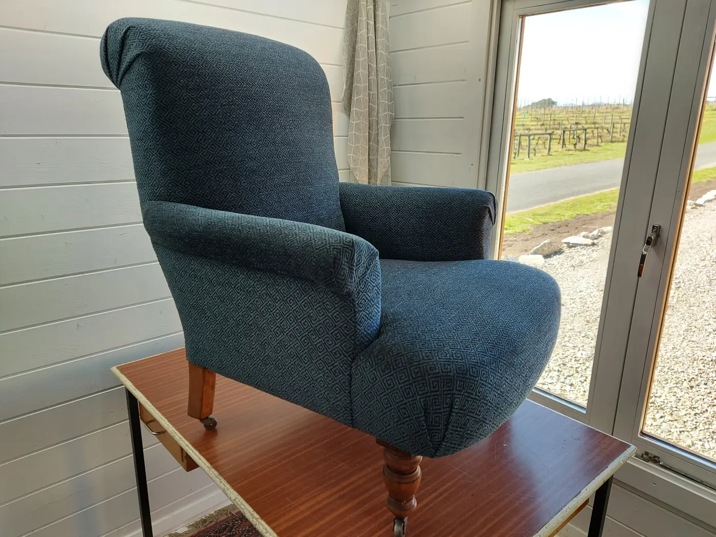 Finished blue upholstered armchair