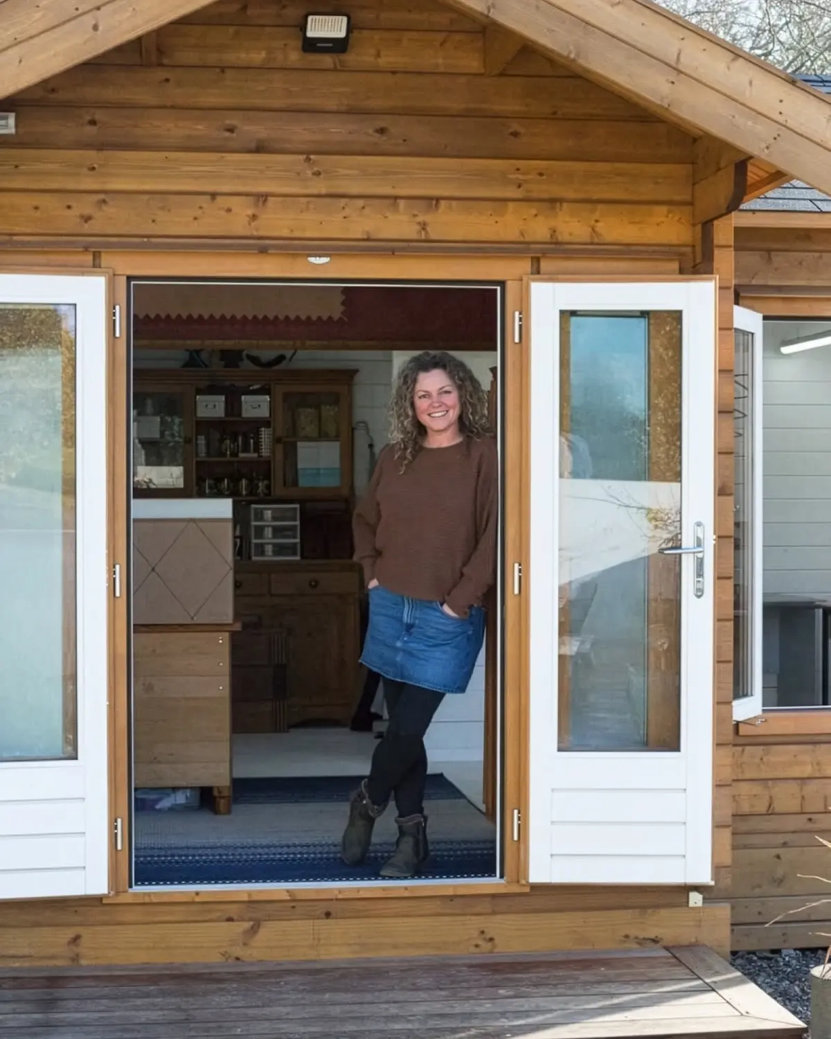 Lisa standing at the entrance to her Upper Moutere upholstery studio